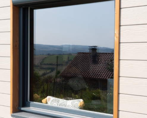 Maison ossature bois avec finition en bardage fibrociment